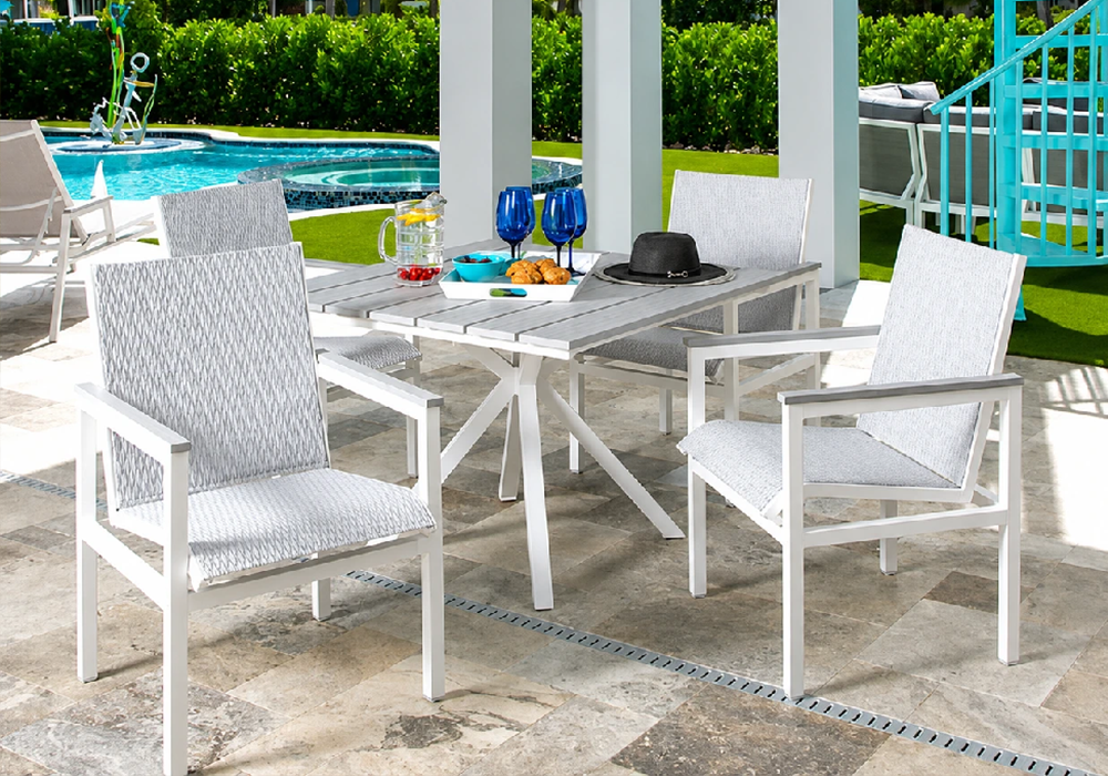 Modern Kingston commercial outdoor dining set with square table beside a luxury swimming pool.